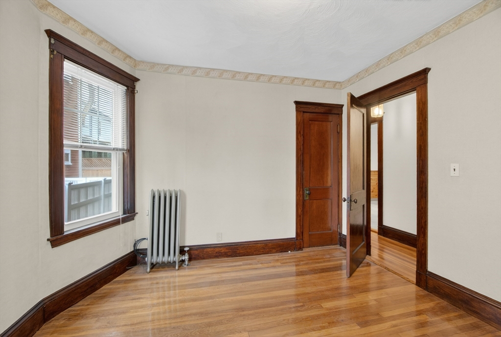 67 Irving Street Somerville, MA 02144 - Photo 15 of 40 a view of empty room with wooden floor and fan