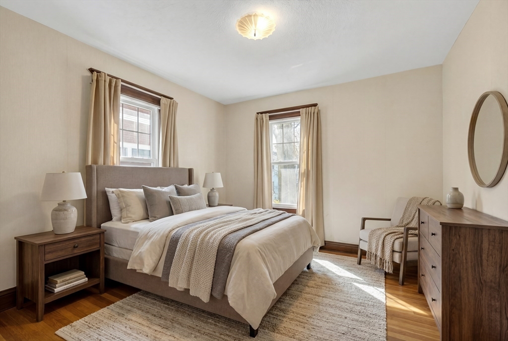 67 Irving Street Somerville, MA 02144 - Photo 28 of 40 a bedroom with a bed a mirror and a window