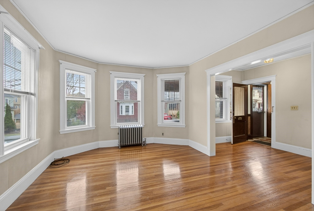 67 Irving Street Somerville, MA 02144 - Photo 6 of 40 a view of empty room with wooden floor and fan