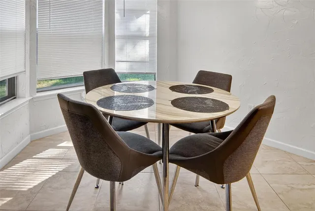 a dining room with furniture and a window