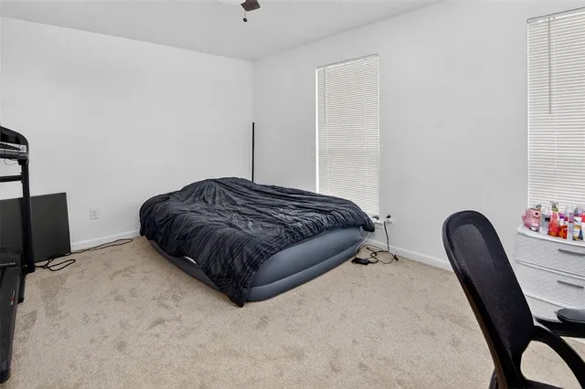 a bedroom with a bed chair and a potted plant