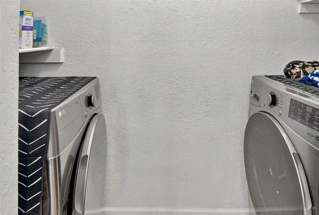 a view of storage and utility room with washer and dryer