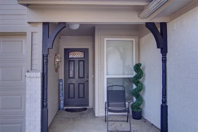 a front view of a house with a potted plant