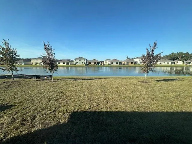 a view of a lake with houses in the back