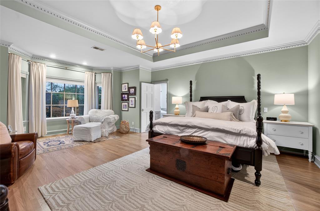 6331 Waggoner Drive Dallas, TX 75230 - Photo 18 of 36 a bedroom with a bed and wooden floor
