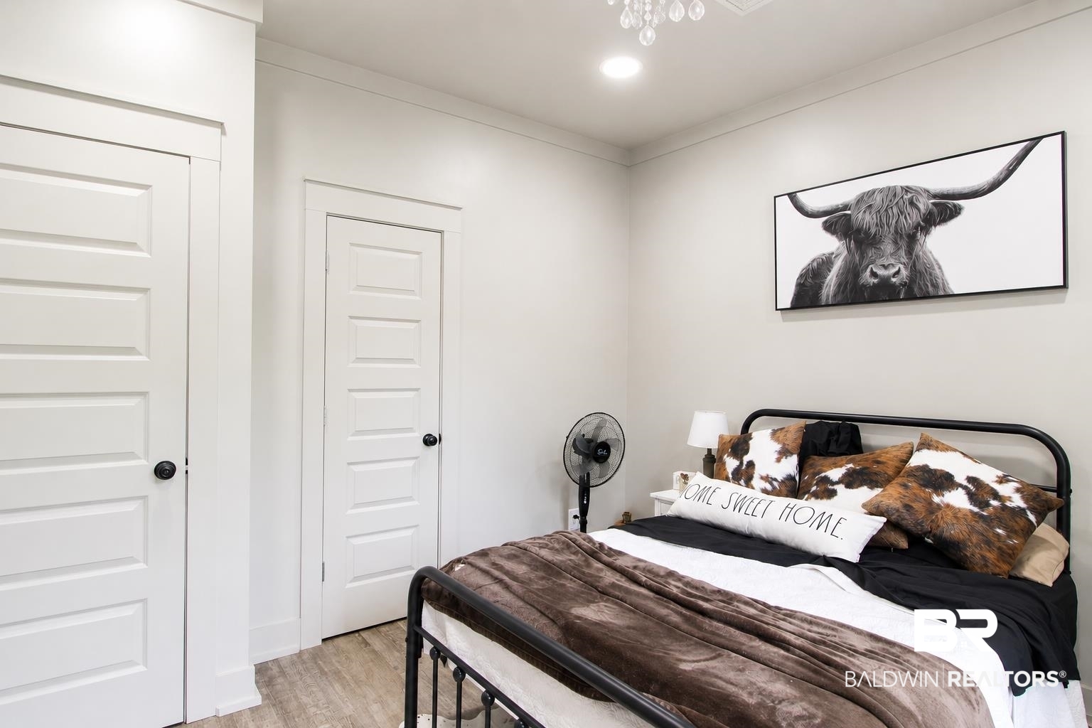 9825 Wolf Creek Ridge Elberta, AL 36530 - Photo 12 of 76 Recessed lighting illuminates this interior space, featuring wood-finish flooring and white paneled doors with black hardware