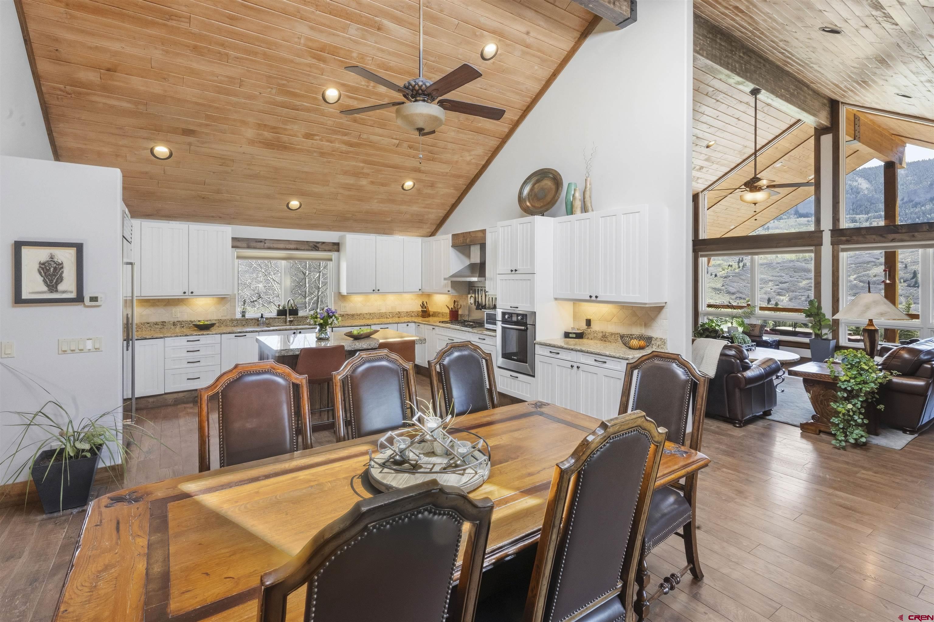 684 Falcon Way Montrose, CO 81403 - Photo 4 of 43 a very nice looking open dining room with kitchen island furniture a large window and kitchen view