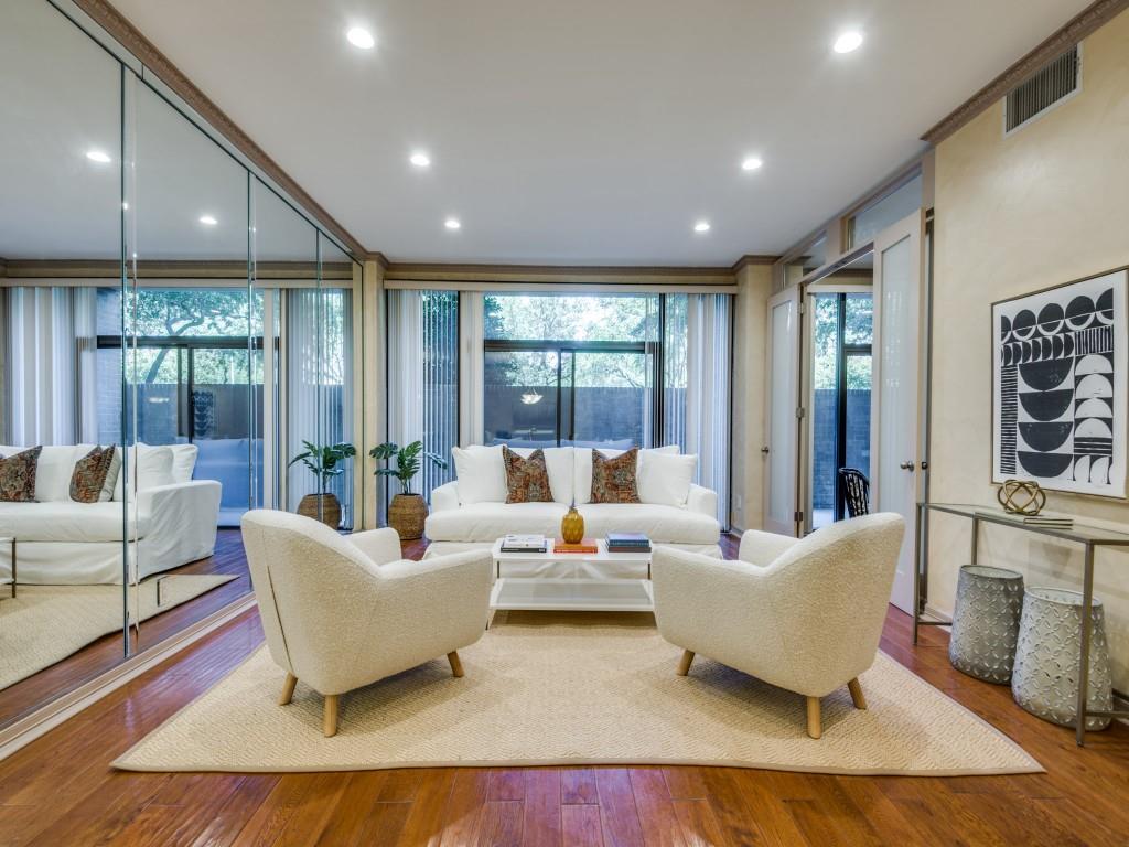 a living room with furniture and large windows