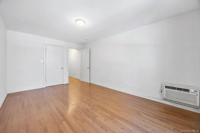 a view of an empty room and wooden floor