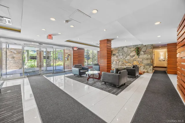 a living room with furniture and large windows