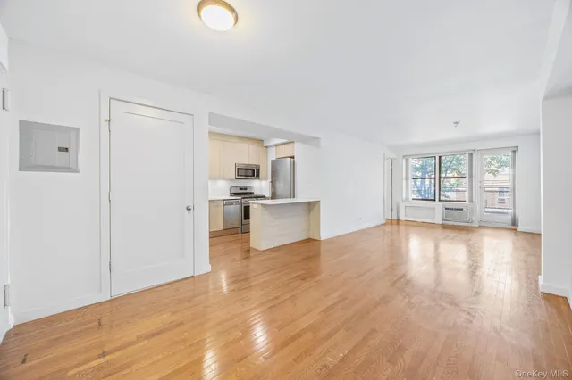 a view of a kitchen with wooden floor and windows