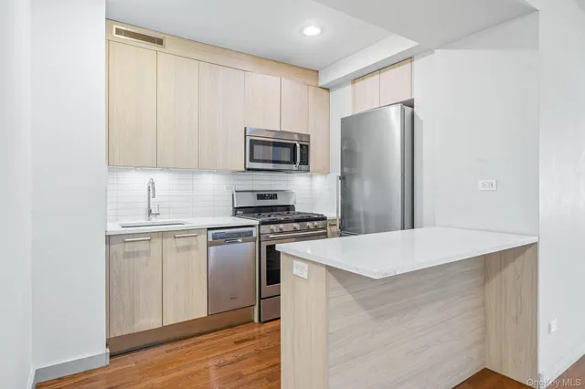 a kitchen with stainless steel appliances granite countertop a refrigerator stove top oven and sink