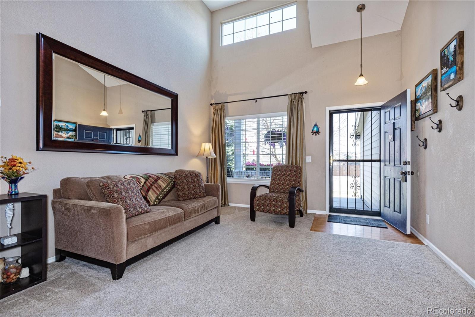9867 Riddlewood Court Highlands Ranch, CO 80129 - Photo 3 of 20 a living room with furniture and a flat screen tv