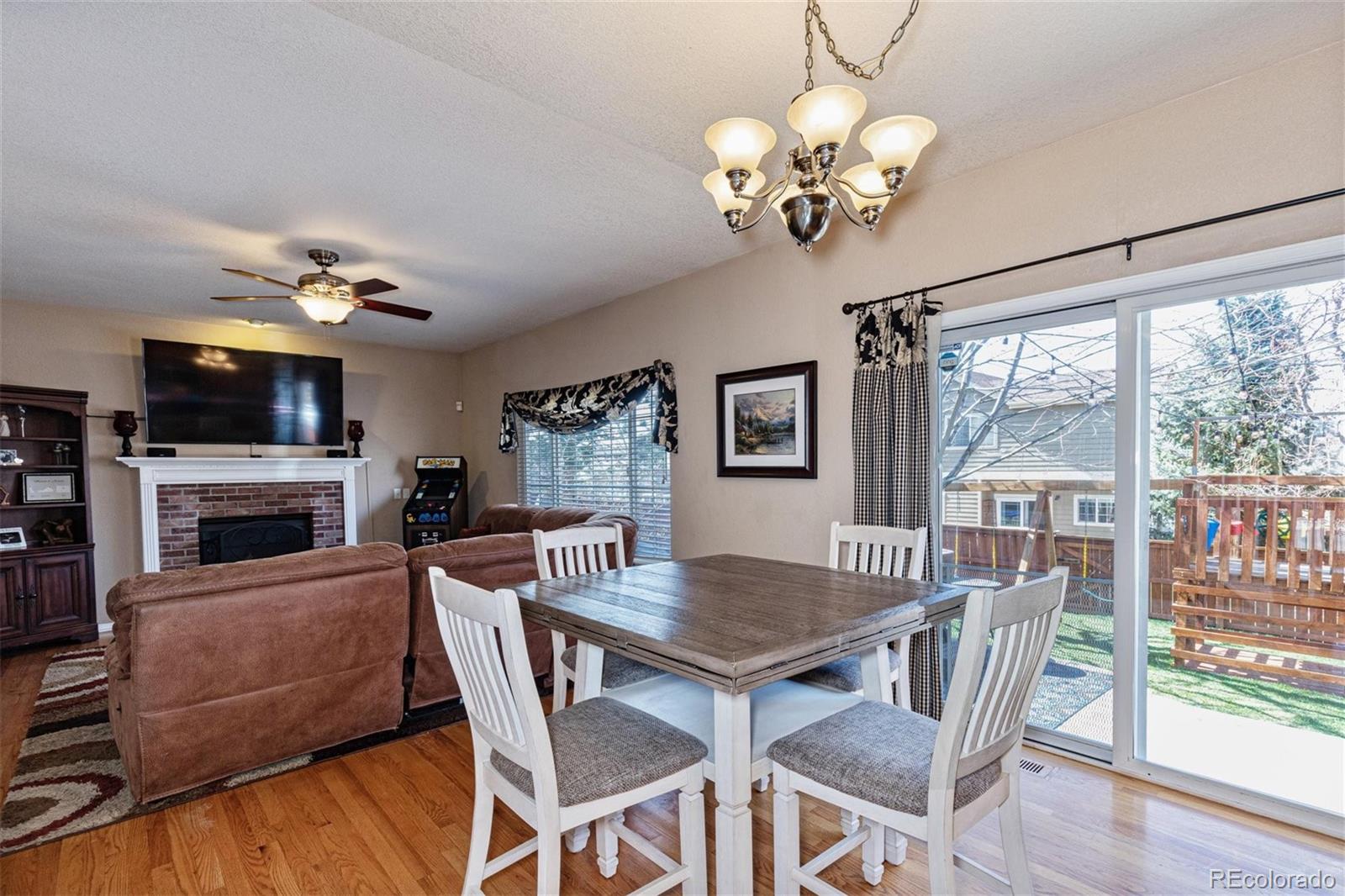 9867 Riddlewood Court Highlands Ranch, CO 80129 - Photo 6 of 20 a view of a dining room with furniture a chandelier and wooden floor