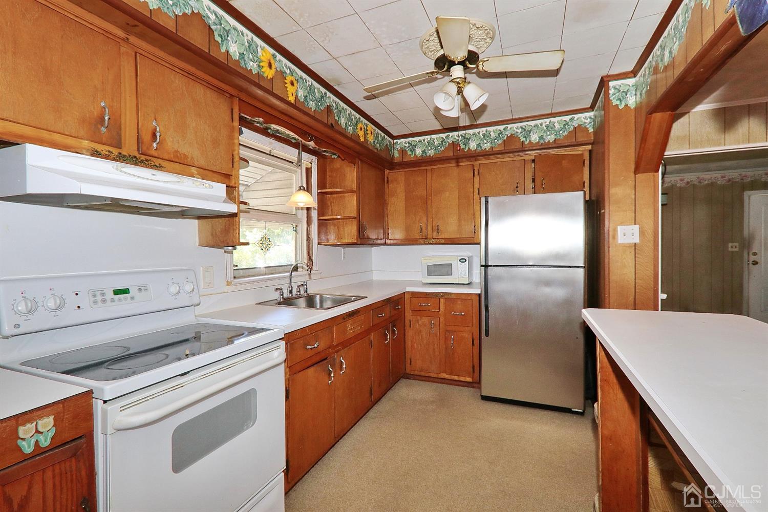 170 East Hill Road Colonia, NJ 07067 - Photo 12 of 25 a kitchen with stainless steel appliances granite countertop a sink a stove and refrigerator