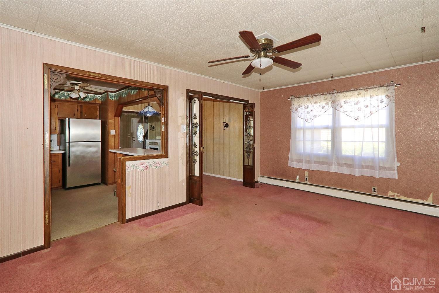 170 East Hill Road Colonia, NJ 07067 - Photo 15 of 25 a view of a livingroom with a ceiling fan & windows