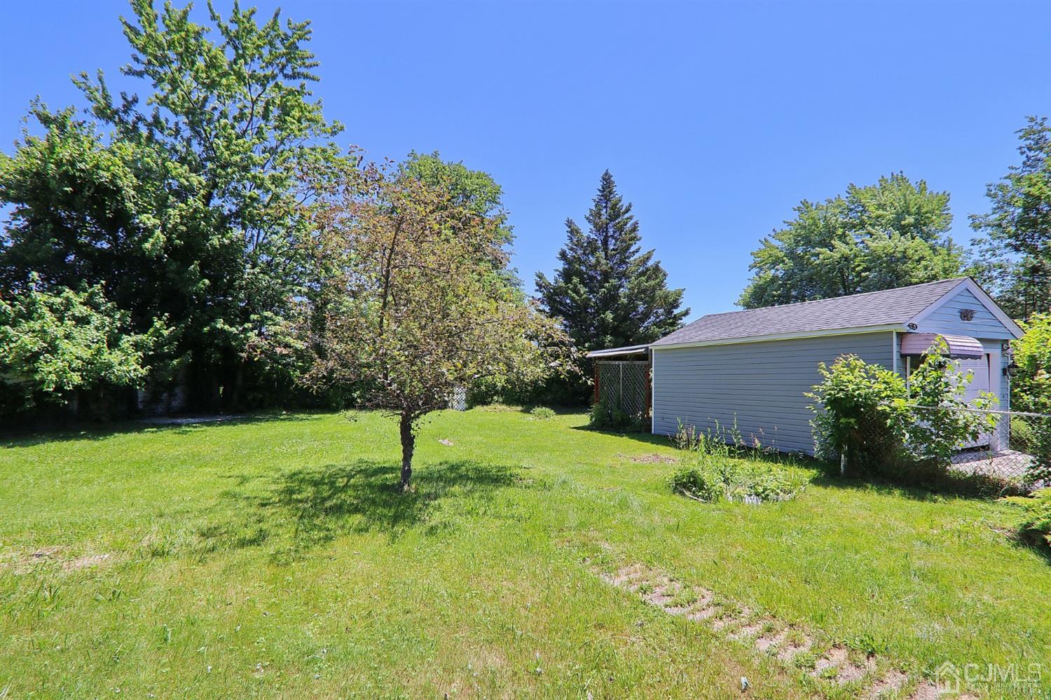 170 East Hill Road Colonia, NJ 07067 - Photo 23 of 25 a house is sitting in middle od the grass