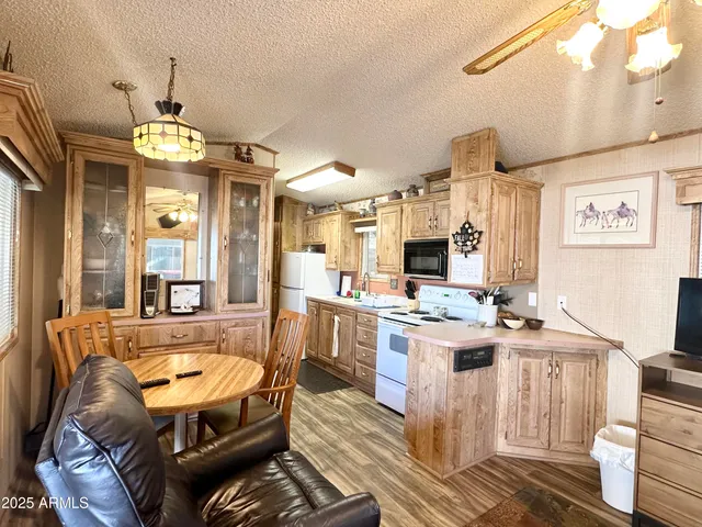 a kitchen with kitchen island granite countertop a stove and a sink