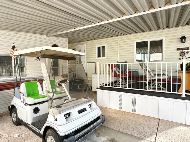 a view of a patio with table and chairs with wooden floor and fence