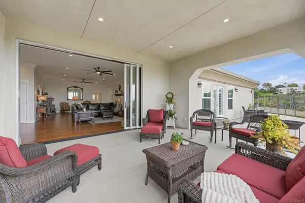 a living room with furniture a rug and a chandelier