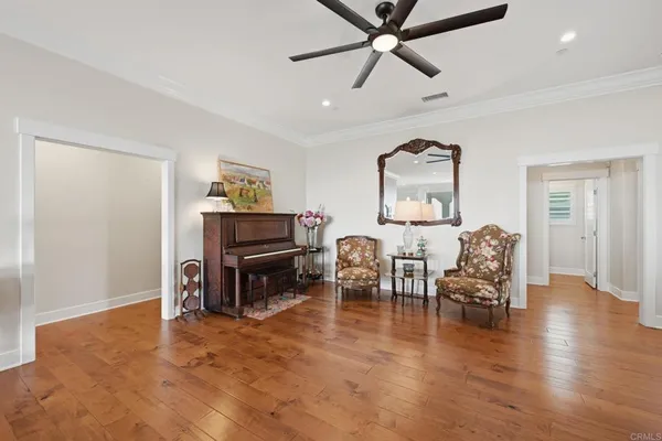 a kitchen with stainless steel appliances kitchen island granite countertop a stove a sink a dining table and chairs with wooden floor