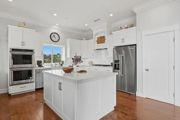 a bathroom with a granite countertop sink and washing machine