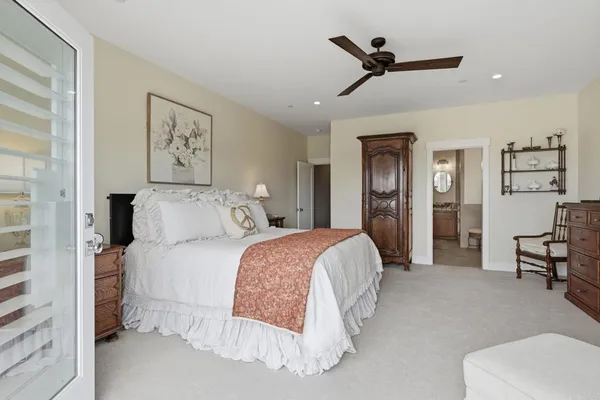 a bathroom with a granite countertop sink a toilet and a mirror