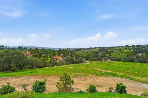 a view of a swimming pool and mountains in the background