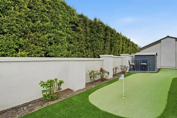 a view of a house with backyard and sitting area