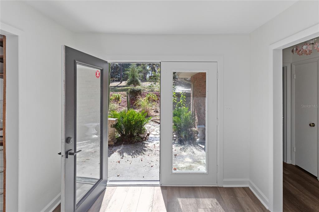 730 Highway 26 Melrose, FL 32666 - Photo 35 of 80 an empty room with wooden floor and windows