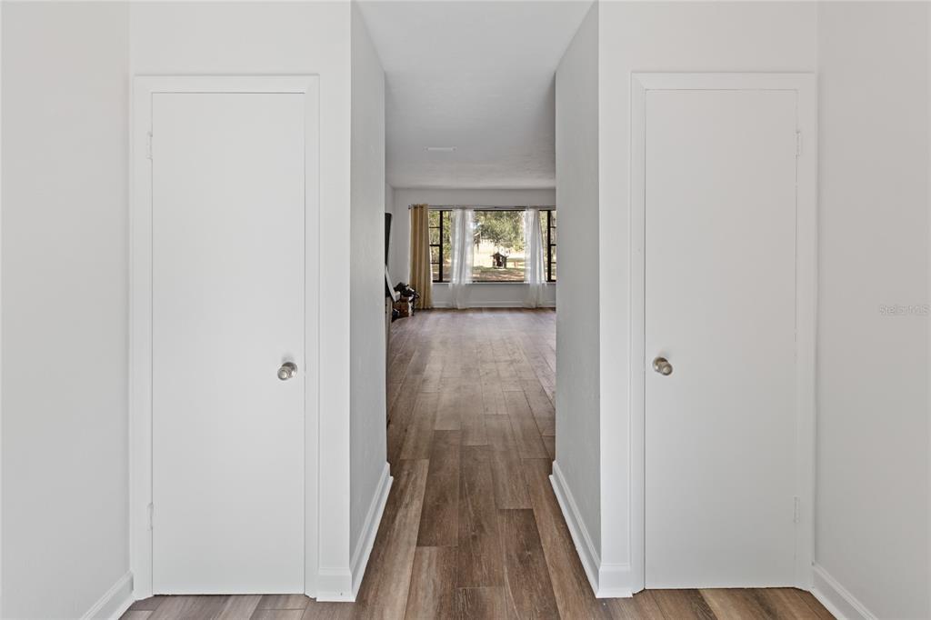 730 Highway 26 Melrose, FL 32666 - Photo 37 of 80 a view of a hallway with wooden floor and a bathroom
