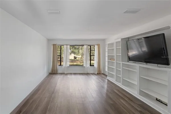 a view of room with window and ceiling fan