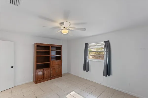 a view of room with window and wooden floor