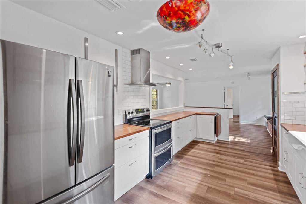 730 Highway 26 Melrose, FL 32666 - Photo 55 of 80 a large kitchen with stainless steel appliances a refrigerator and a stove top oven