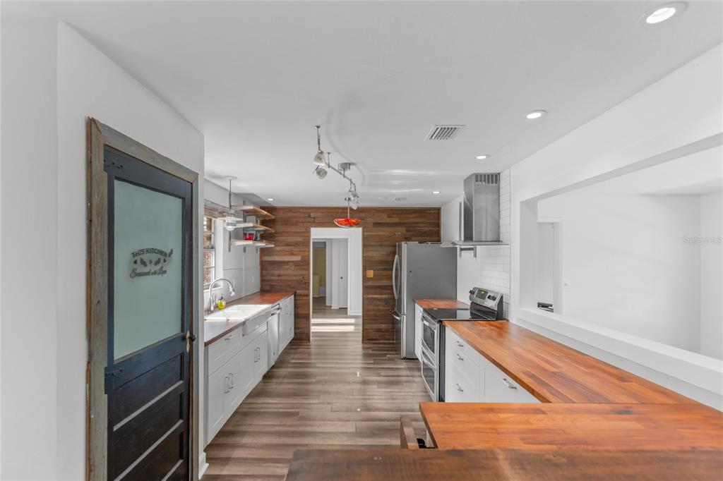 730 Highway 26 Melrose, FL 32666 - Photo 57 of 80 a open kitchen with stainless steel appliances granite countertop a refrigerator and a sink