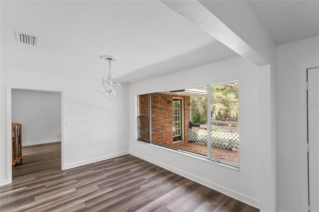 730 Highway 26 Melrose, FL 32666 - Photo 60 of 80 a view of an empty room with wooden floor and a window
