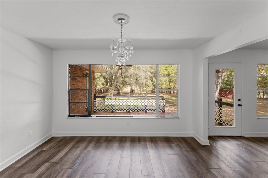 730 Highway 26 Melrose, FL 32666 - Photo 72 of 80 a view of an empty room with wooden floor and a window