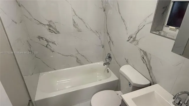 a kitchen with stainless steel appliances granite countertop a stove a refrigerator and a microwave