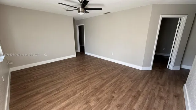 wooden floor in an empty room and a window