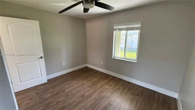 a bathroom with a glass door and a hallway