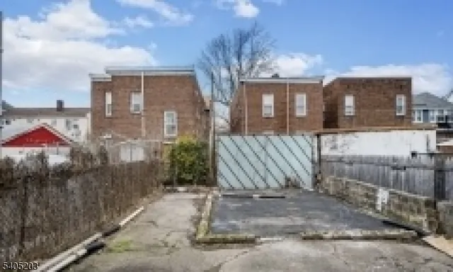 a view of an empty room with wooden walls