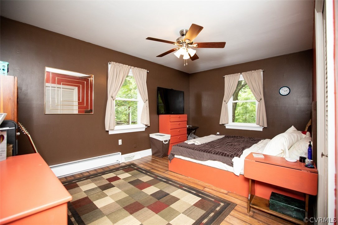 1213 West Osborn Road Farmville, VA 23901 - Photo 18 of 37 a bedroom with a bed and wooden floor