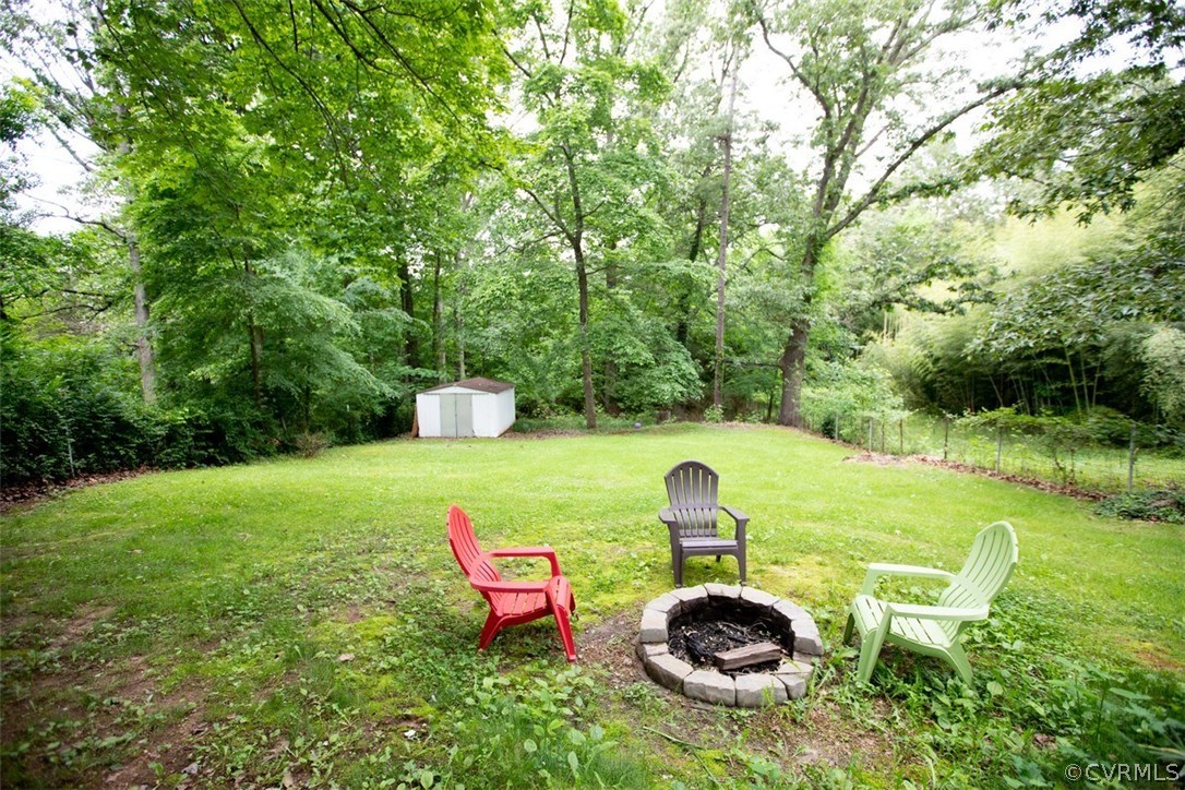 1213 West Osborn Road Farmville, VA 23901 - Photo 34 of 37 a view of a backyard with table and chairs plants and large trees