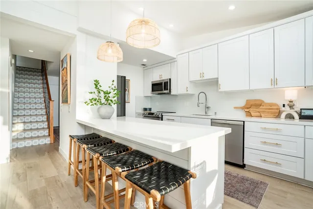 a view of a dining room with furniture and a potted plant