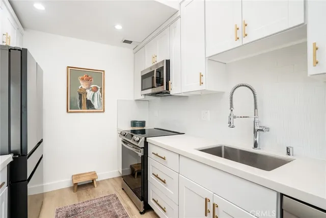 a kitchen with a sink stove and cabinets