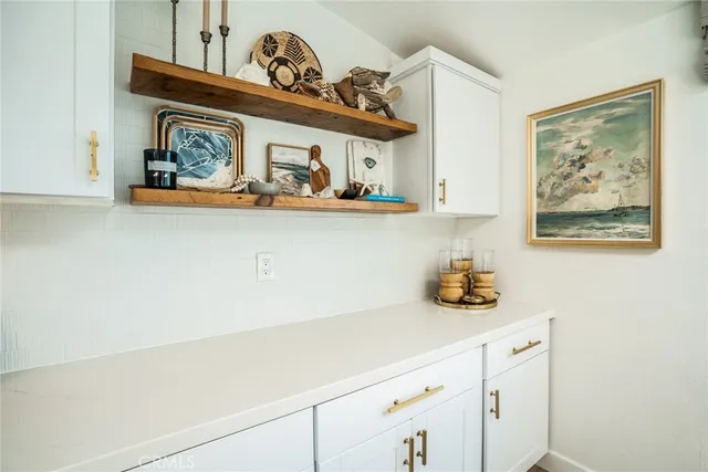a view of a kitchen with stainless steel appliances granite countertop a sink and cabinets
