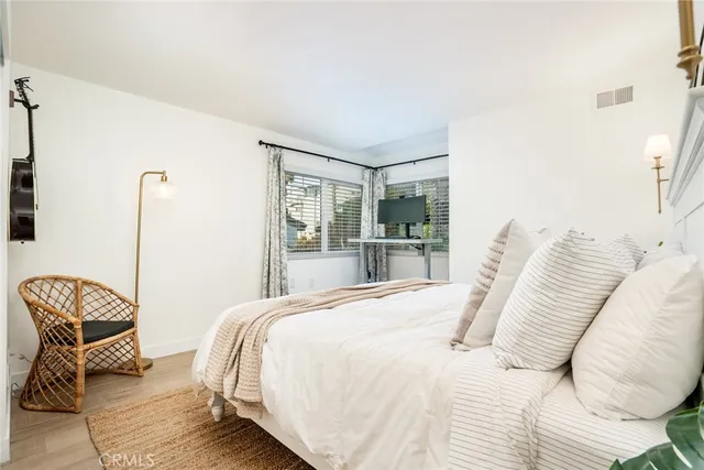 a bedroom with a bed and a chair