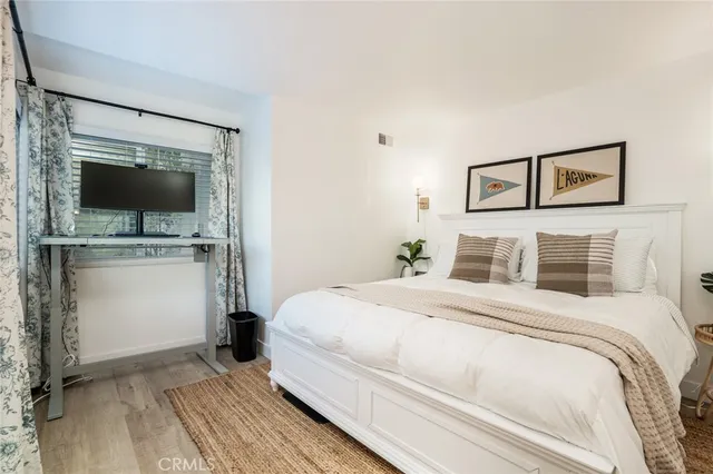 a bedroom with a bed and a flat screen tv