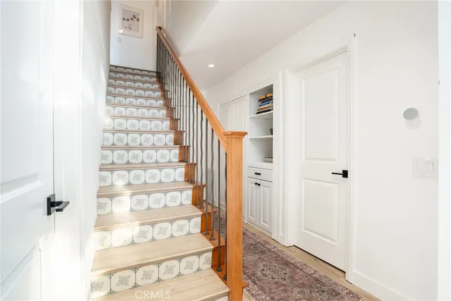 a view of a hallway with wooden floor and entryway