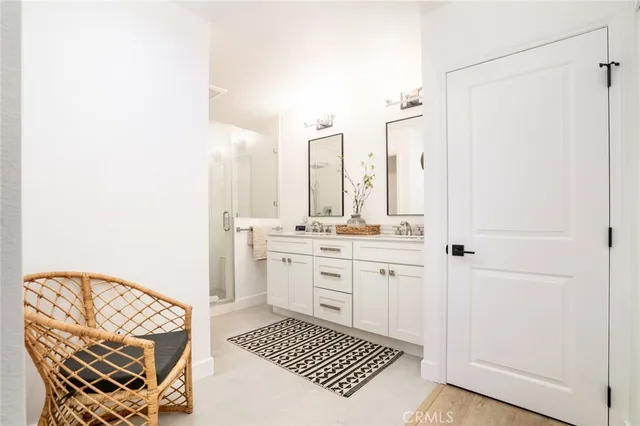 a bathroom with a sink a mirror and a shower